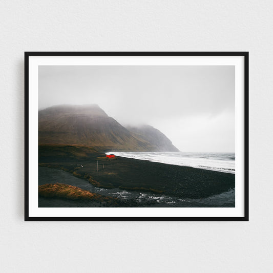 Iceland fine art photography print featuring Westfjords red cabin on a black sand beach